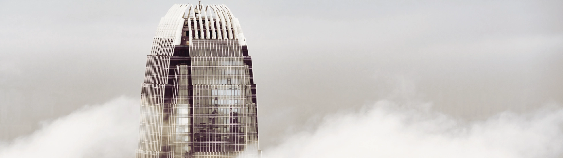 Skyscrapper building peaking through the clouds