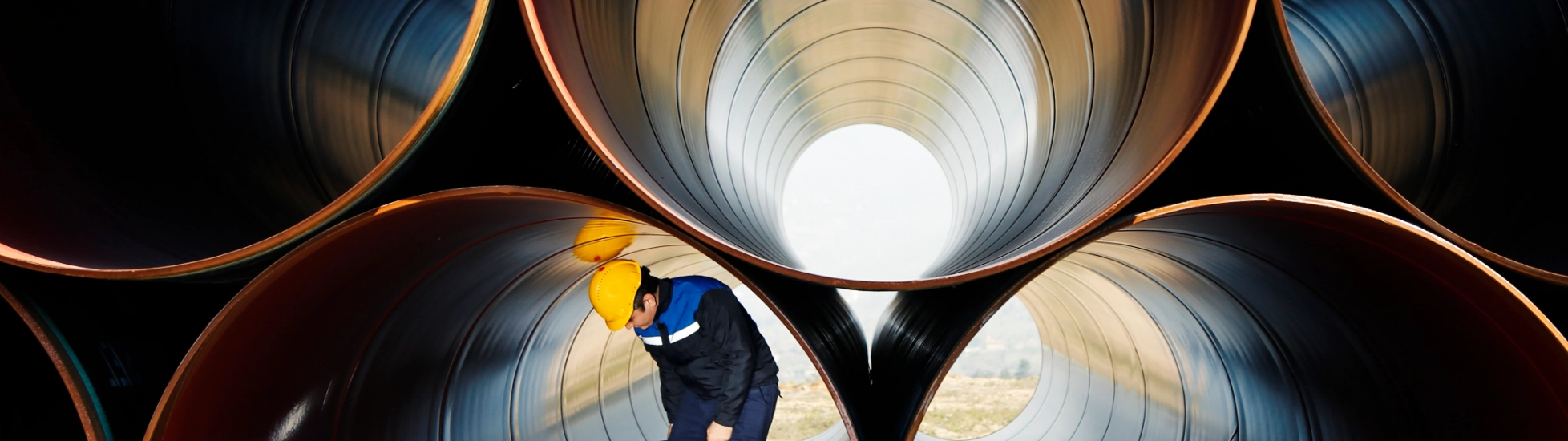 Worker inside industrial pipes